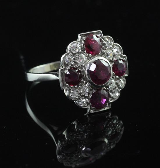 A 1940s platinum, ruby and diamond cluster ring, size M.